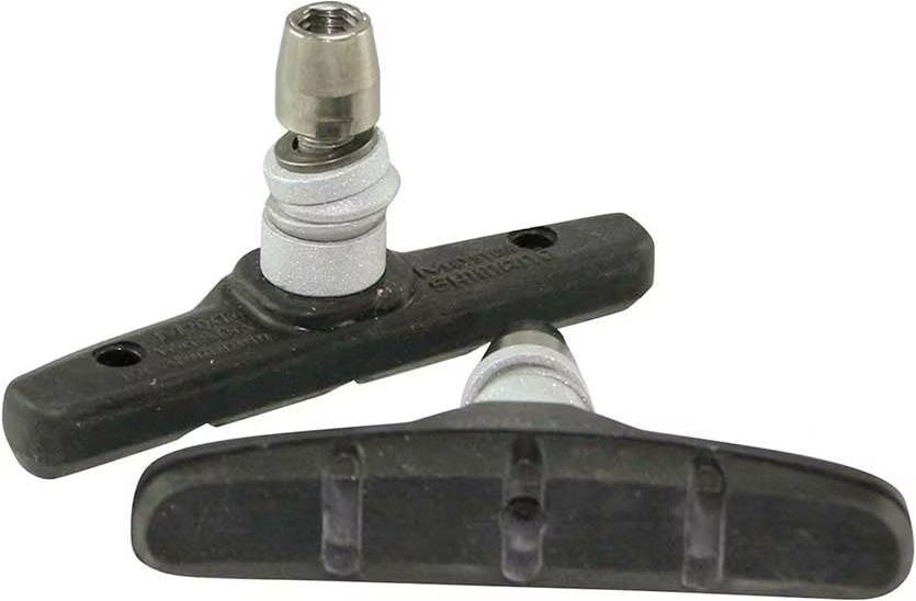 Two bicycle brake shoes with a metal mounting bracket on a white background