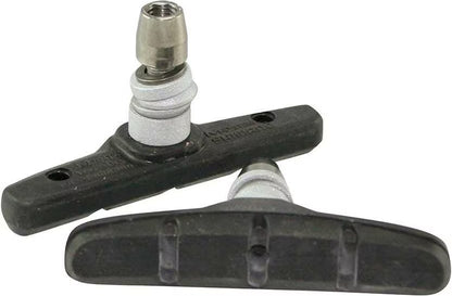 Two bicycle brake shoes with a metal mounting bracket on a white background